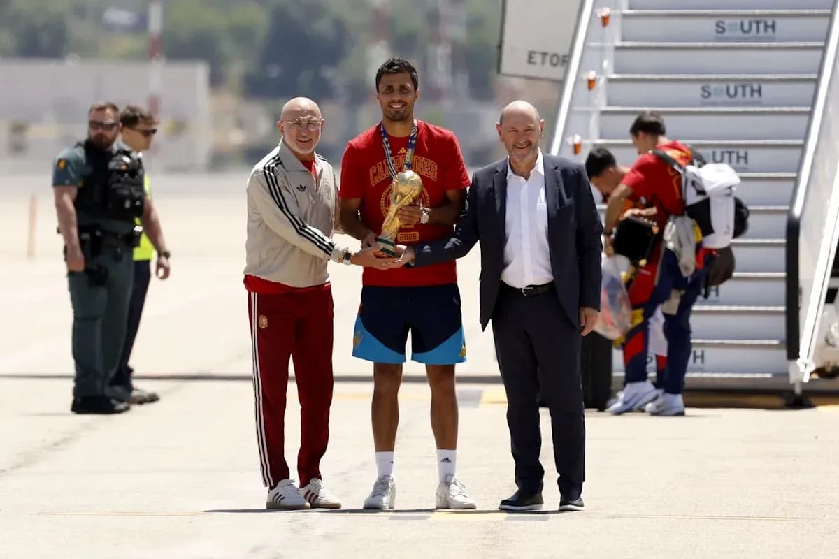 Players and officials celebrating World Cup victory at airport