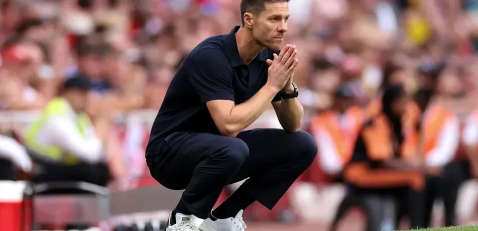 Coach squatting on the sideline during match