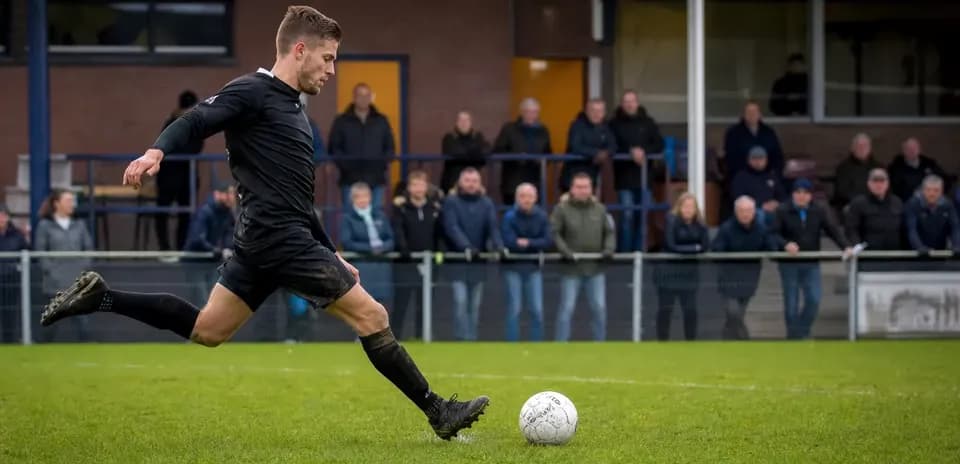 Player kicking a soccer ball during match