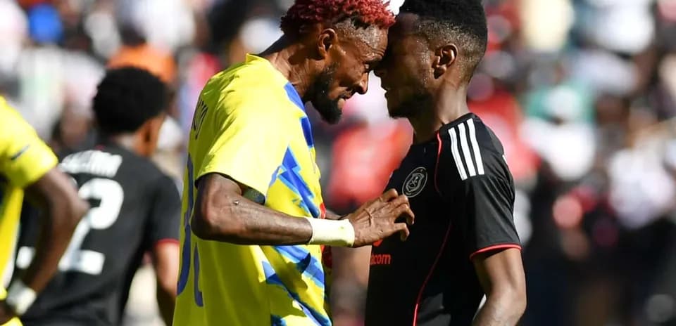 Players from La Cure Waves and Orlando Pirates clashing