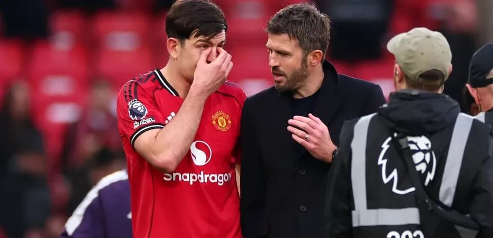 Player discussing with coach after match at stadium