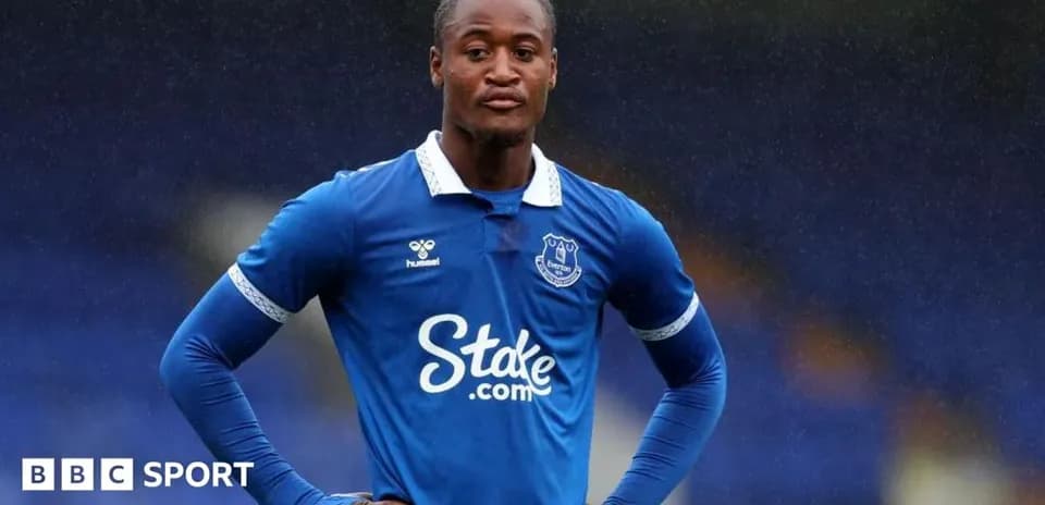 Player in Everton kit standing on the field