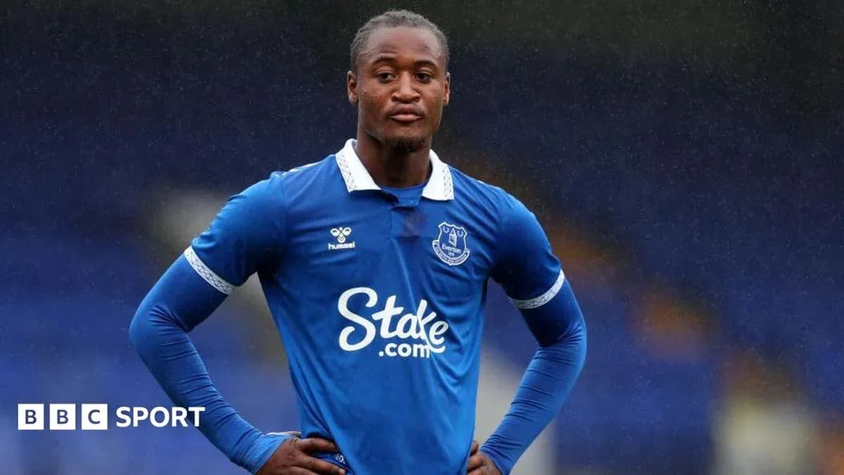 Player in Everton kit standing on the field