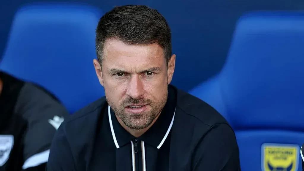 Coach sitting on bench during match preparation