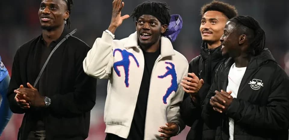 Four players celebrating together on the field