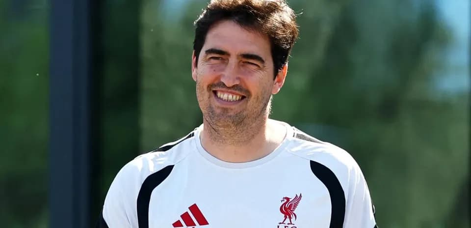 Coach wearing Liverpool kit during training session