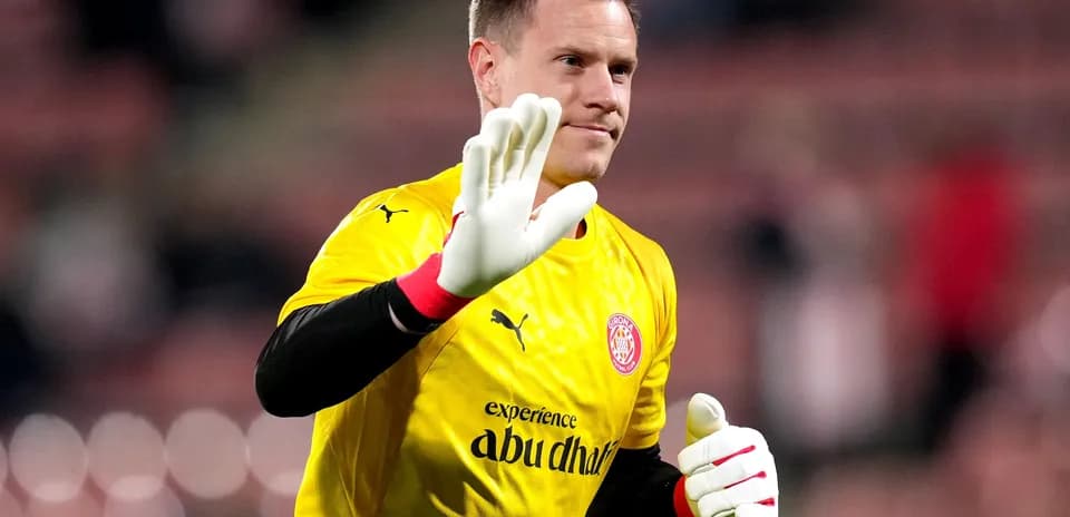 Goalkeeper waving while wearing yellow jersey and gloves