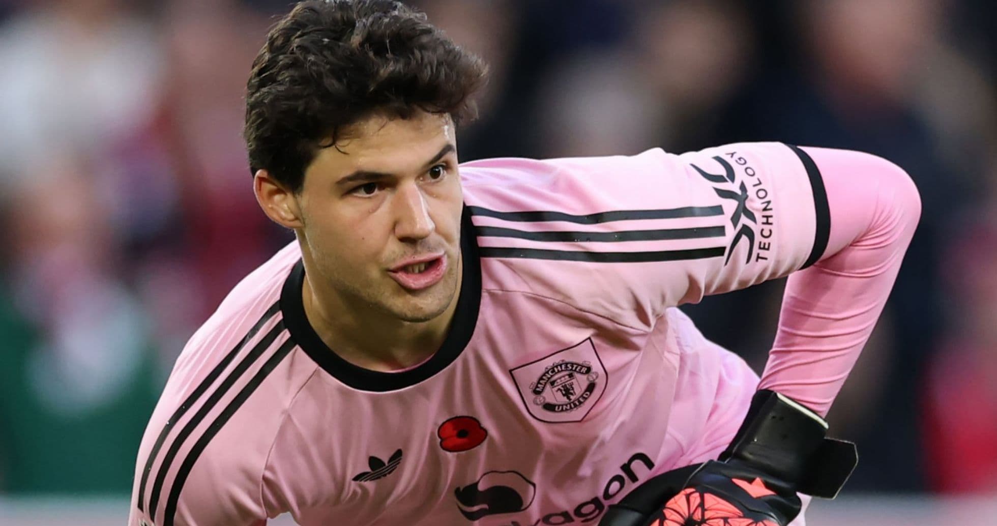 Goalkeeper in pink kit preparing to play