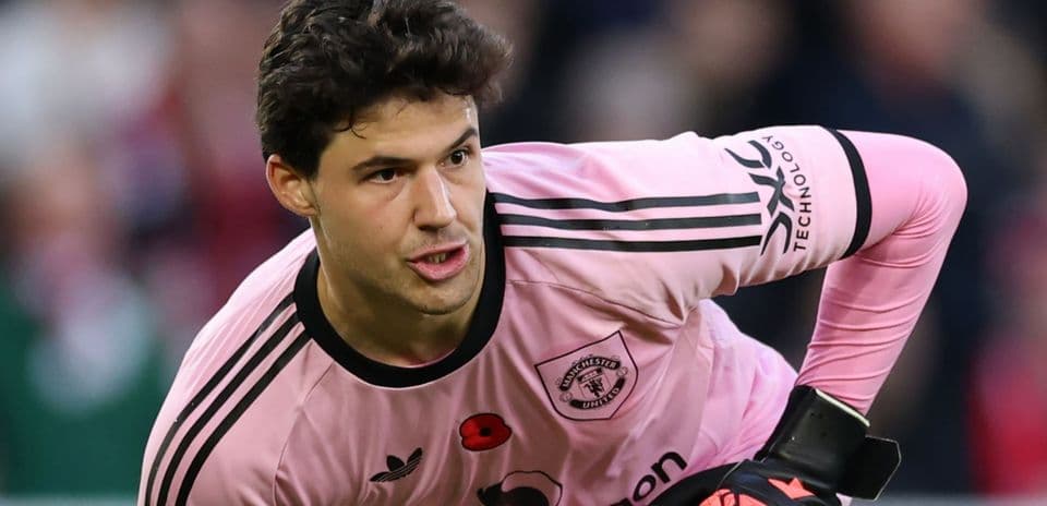 Goalkeeper in pink kit preparing to play