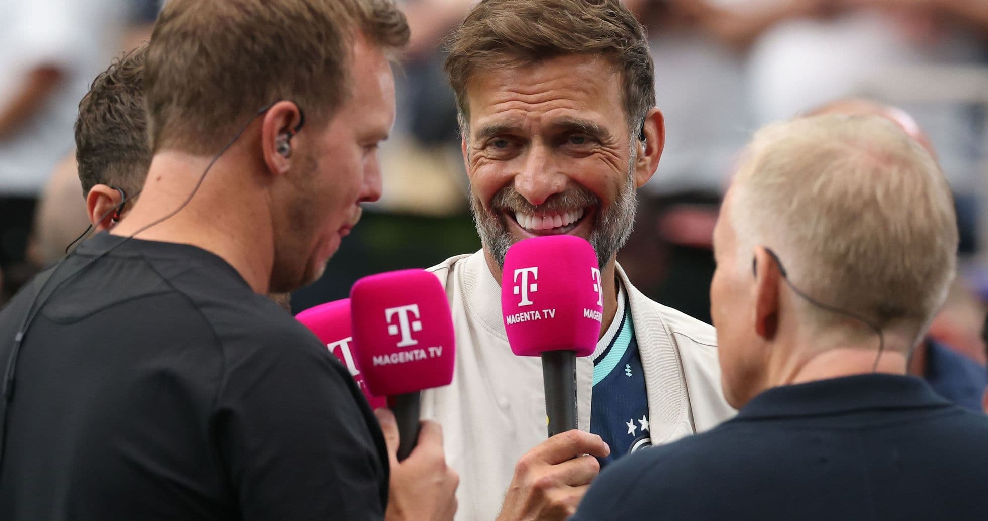 Interview with hosts holding pink microphones