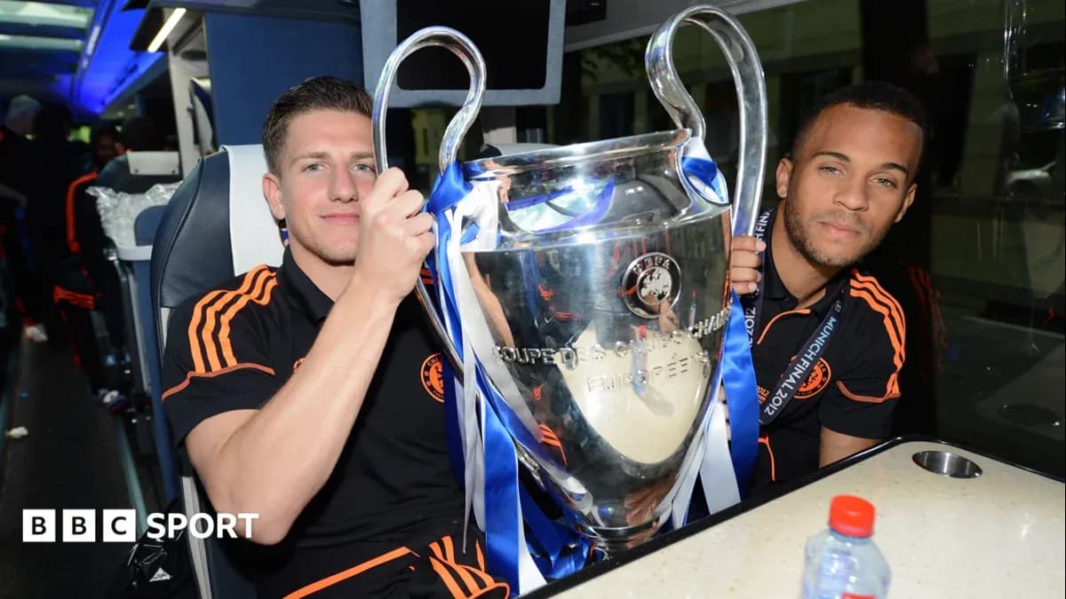 Two players celebrating with UEFA Champions League trophy