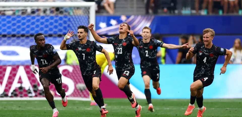 Players celebrating after scoring a goal during match