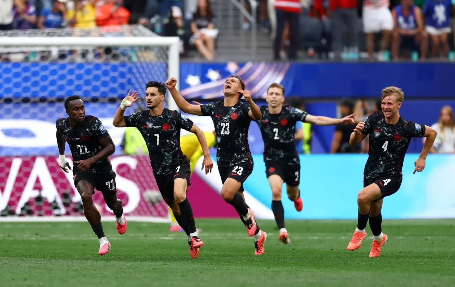 Players celebrating after scoring a goal during match