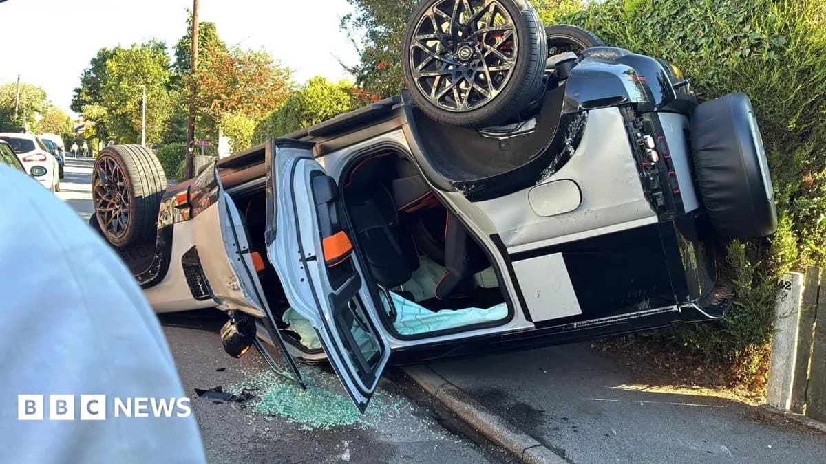 Upside-down car on roadside with shattered glass
