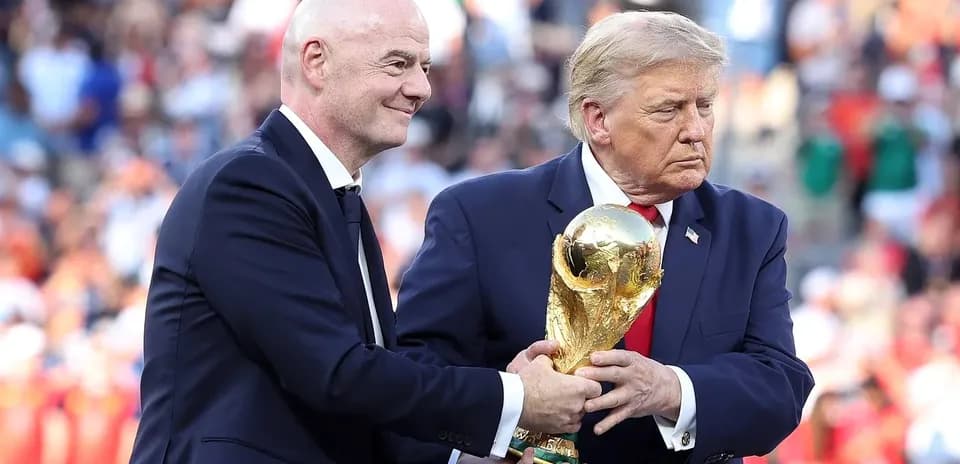 Gianni Infantino and Donald Trump holding World Cup trophy