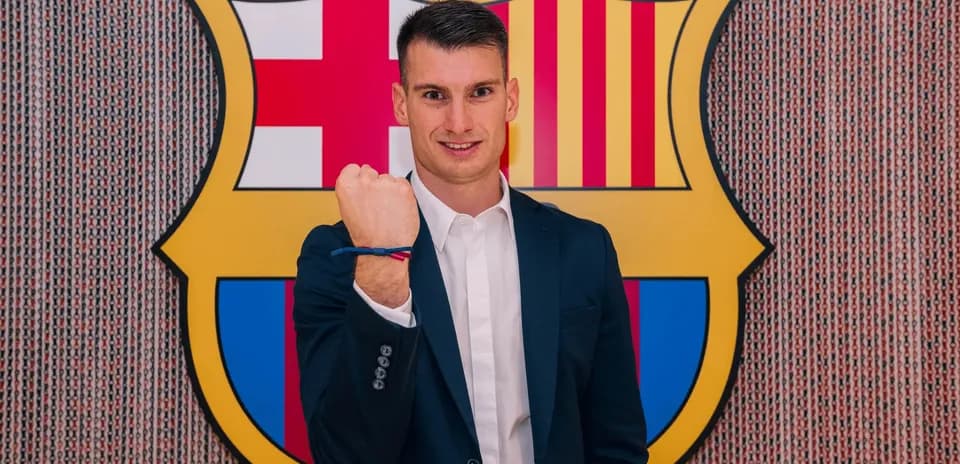 Player posing in front of FC Barcelona logo