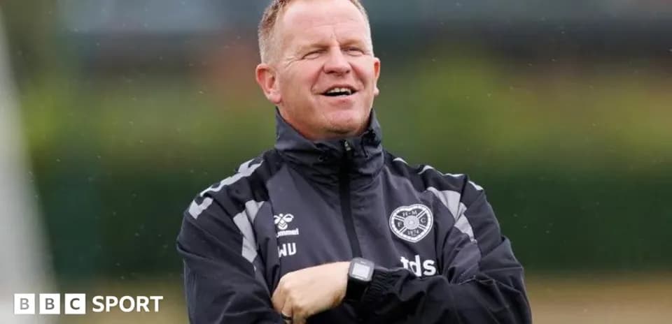 Coach observing training session with arms crossed