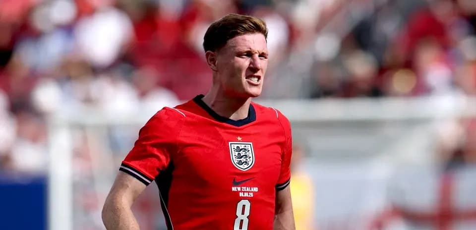 Player in red England jersey during match action