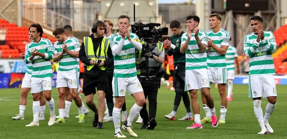 Celtic players applauding fans after the match