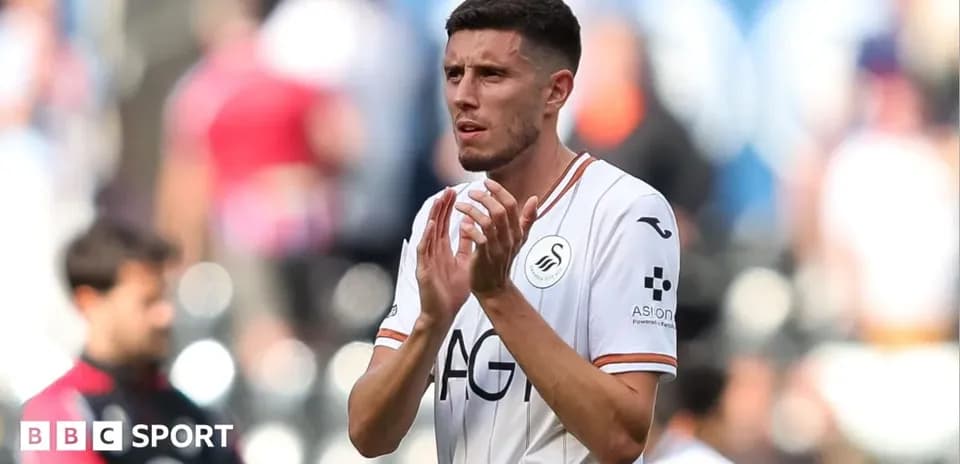 Player applauding fans after match in Swansea kit
