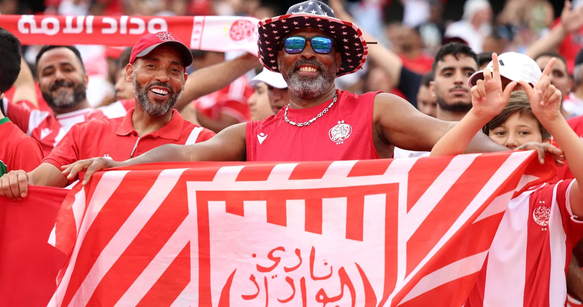 Fans celebrating with a club flag at a match