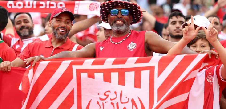 Fans celebrating with a club flag at a match