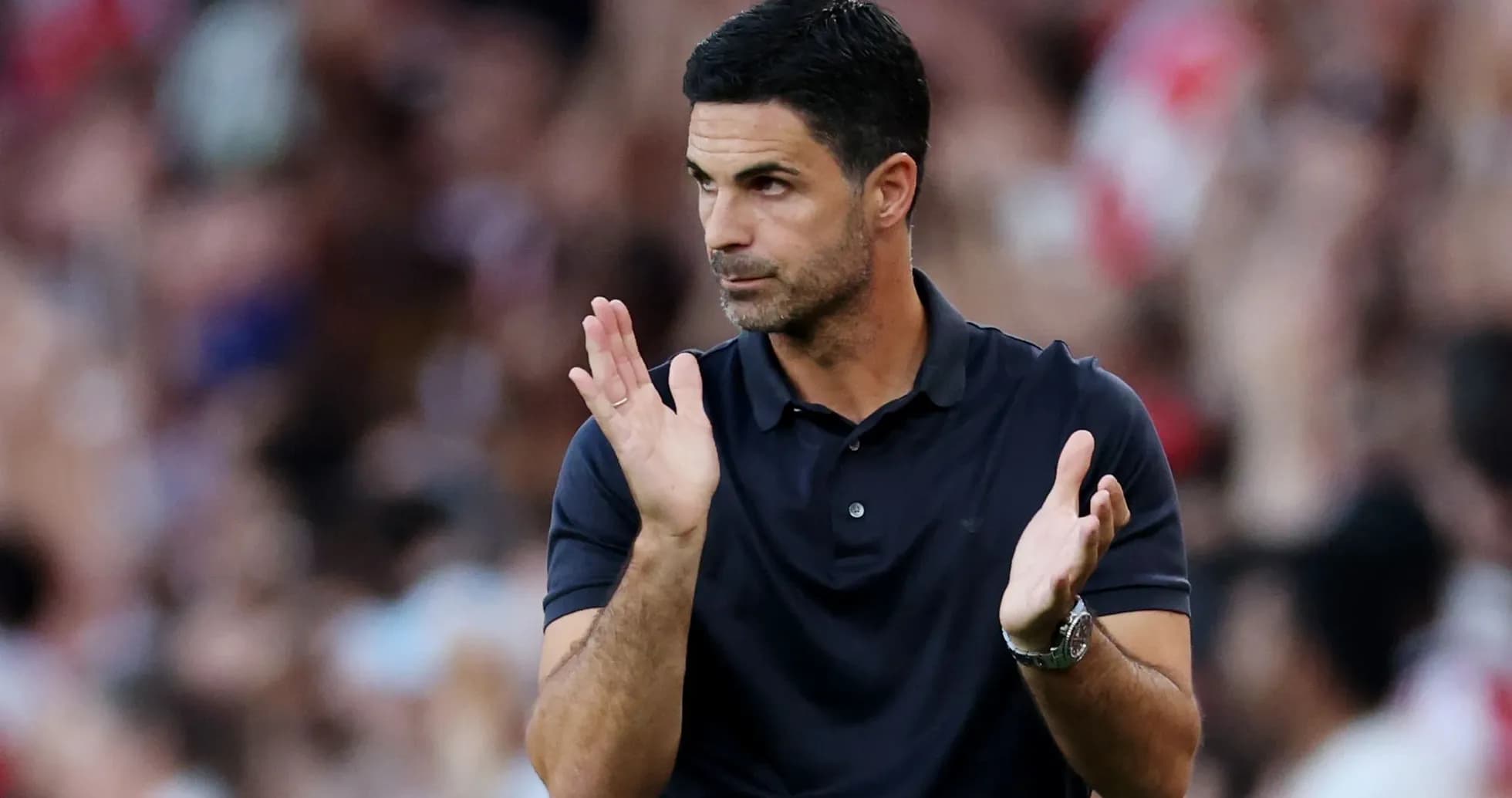 Coach applauding during a match on the sideline