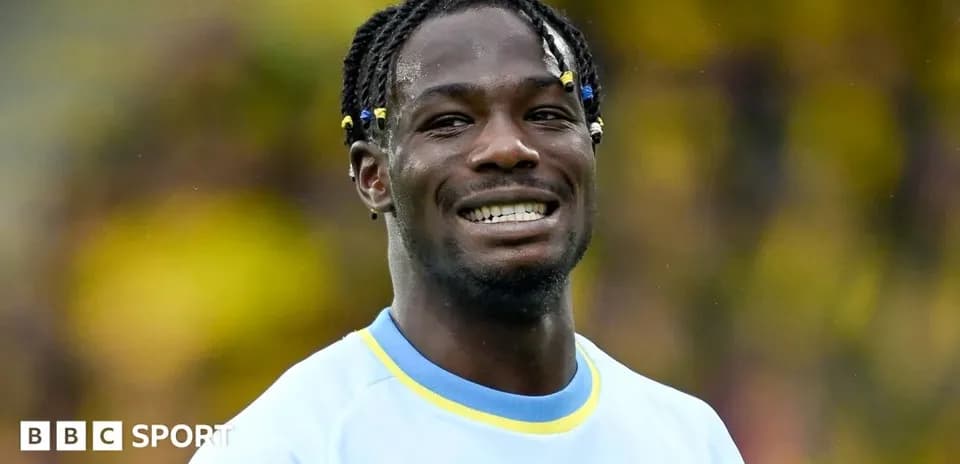 Player smiling while wearing team jersey on field