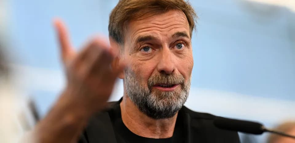 Manager speaking during press conference with microphone