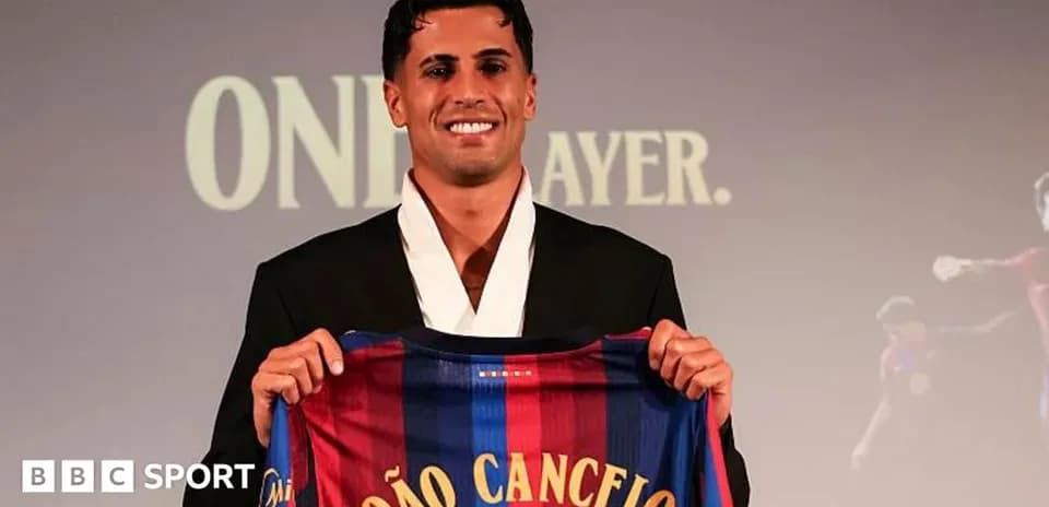 Player holding FC Barcelona jersey during presentation