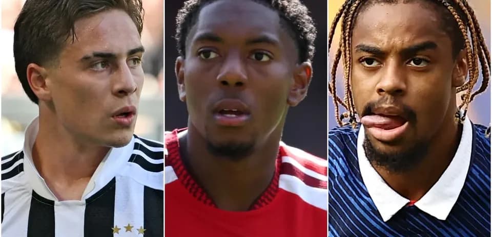 Three soccer players in team jerseys looking forward