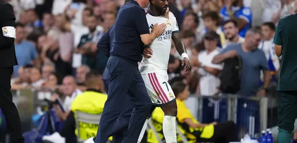 Coach speaking to player during match substitution