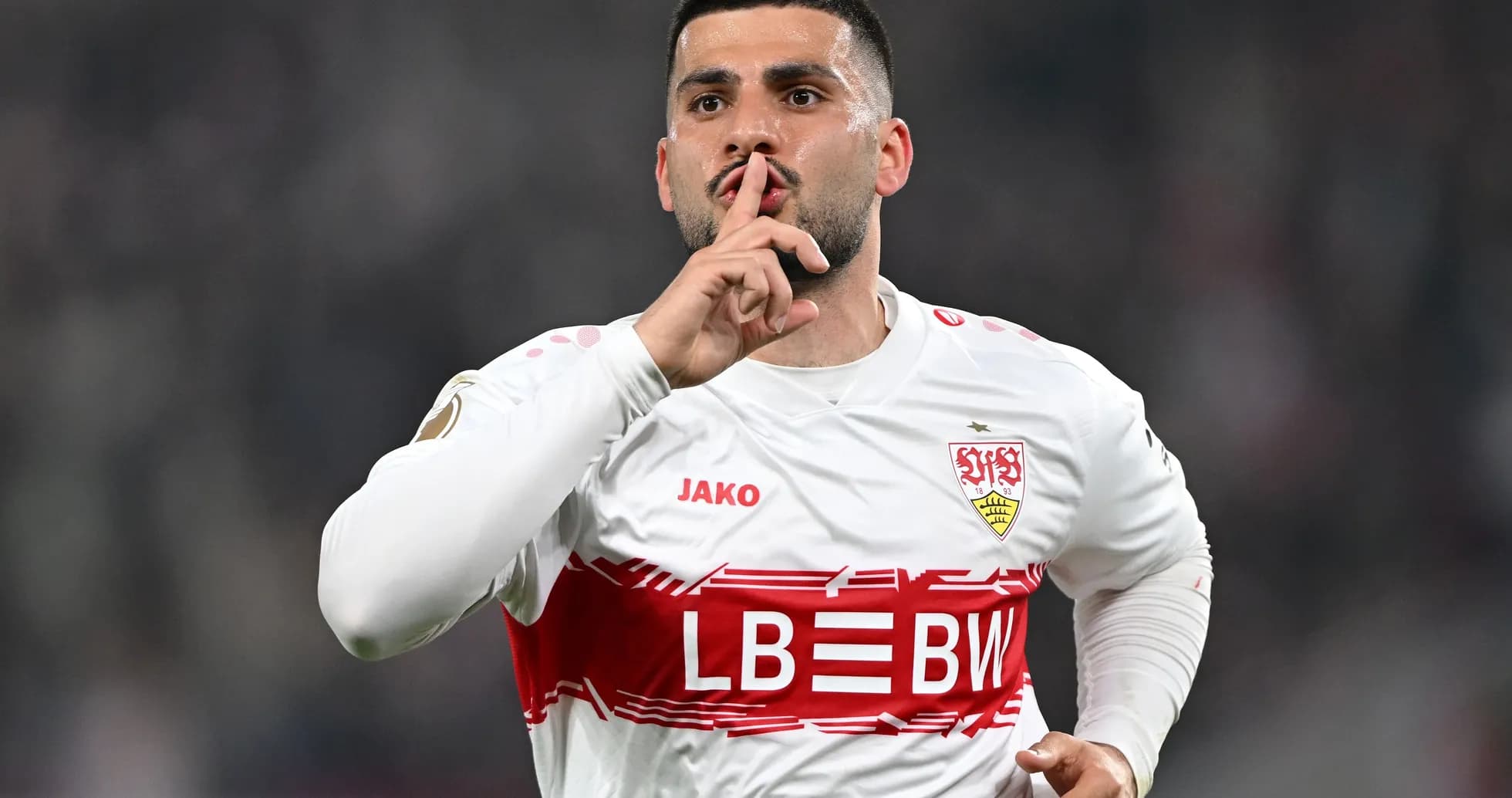 Player celebrating with a shushing gesture after scoring