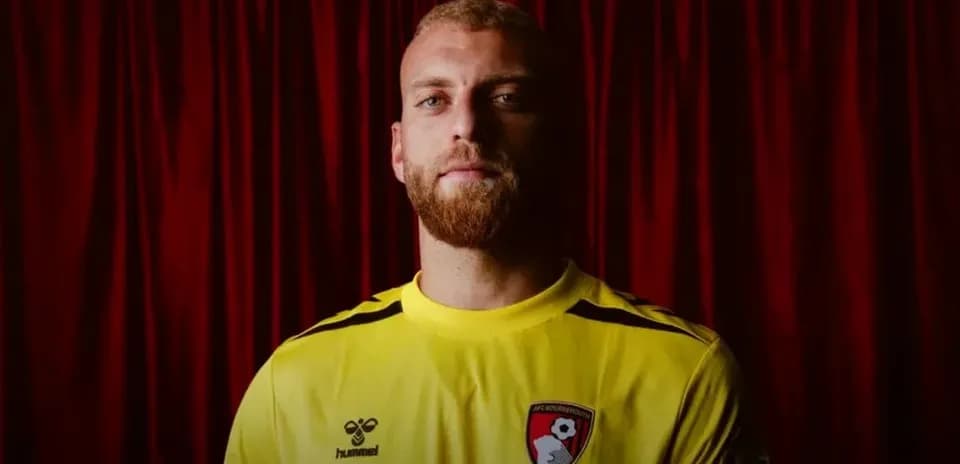 Goalkeeper wearing yellow jersey with AFC Bournemouth badge