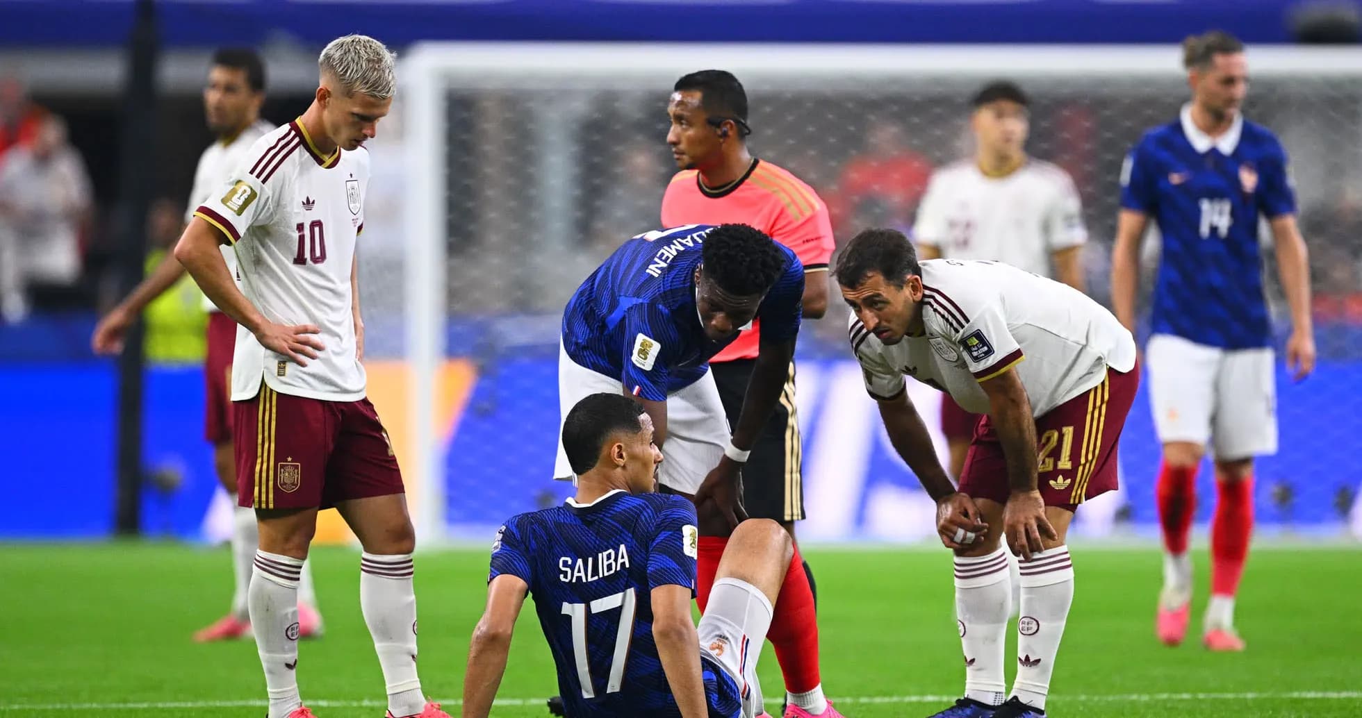 Players attending to an injured teammate on field