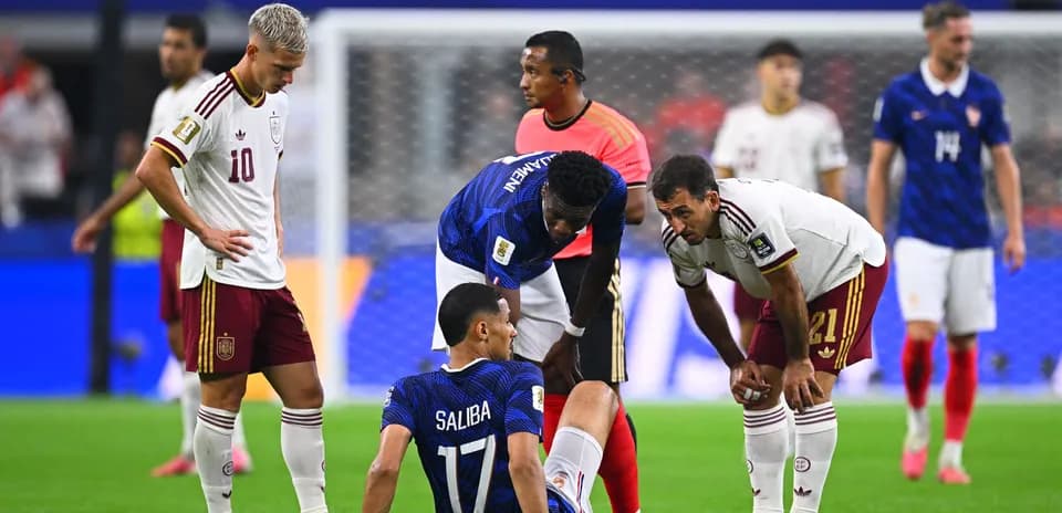 Players attending to an injured teammate on field