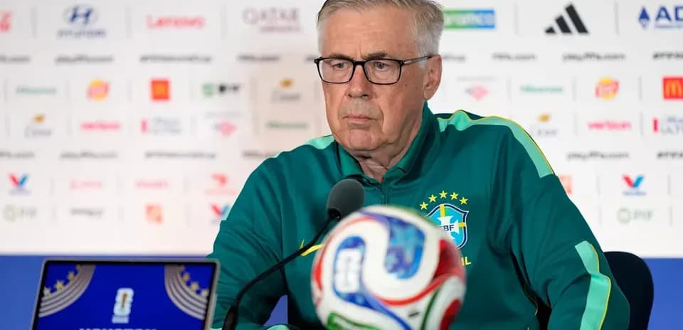 Manager speaking at press conference with football