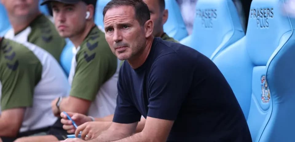 Manager sitting on bench during match