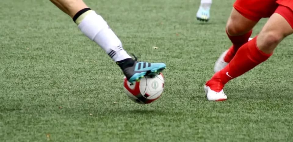 Players contesting the ball during football match