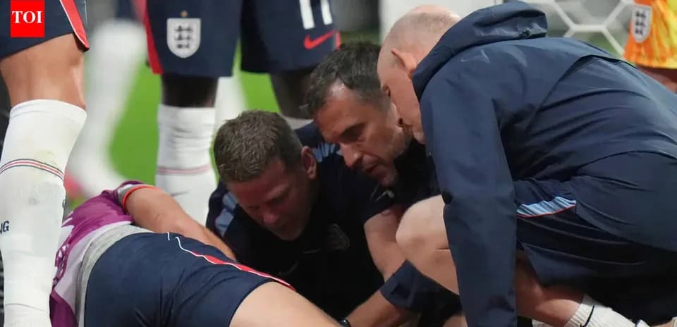 Coaches attending to injured player on the field