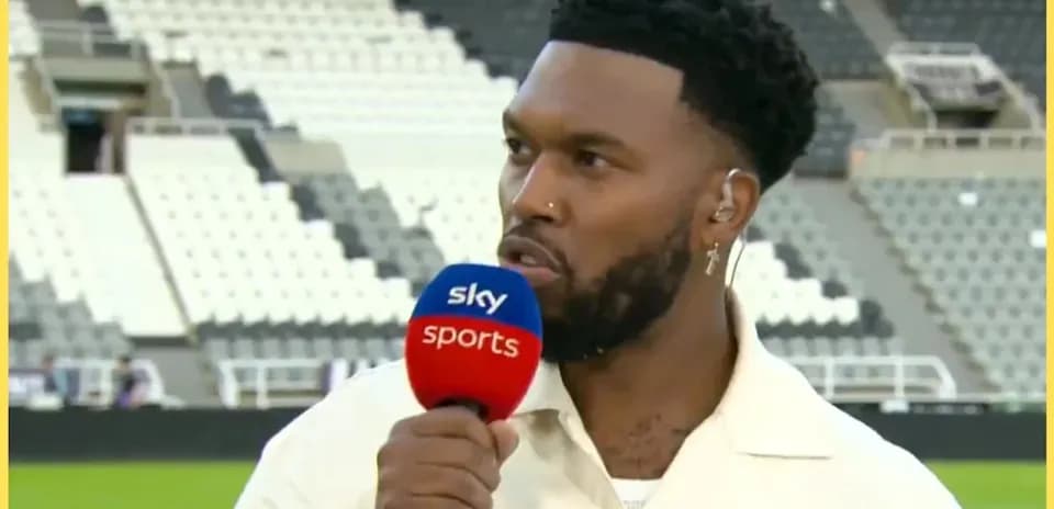 Sportscaster speaking into microphone at stadium