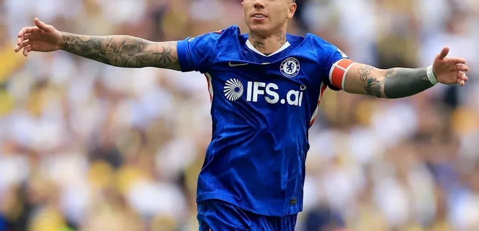 Player celebrating in Chelsea blue kit with arms outstretched