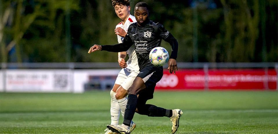Two players competing for the ball in football