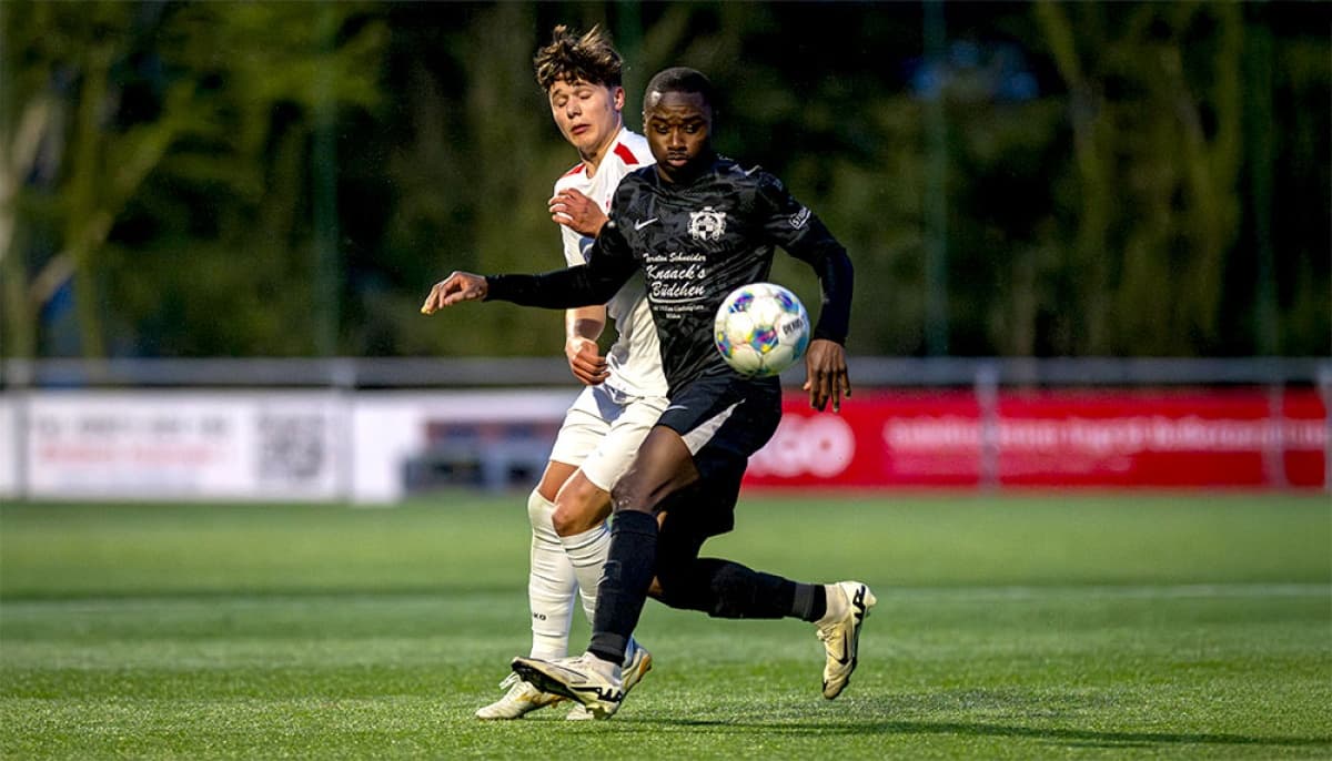 Two players competing for the ball in football