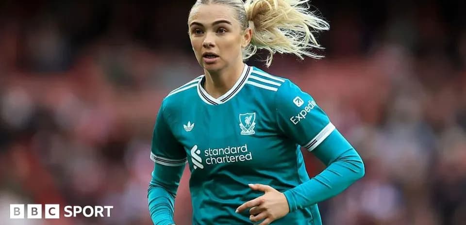 Player in teal Liverpool kit running on field