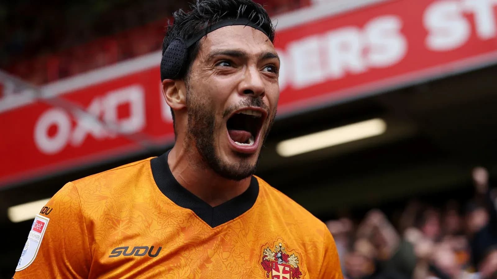 Player celebrating with arms raised in excitement