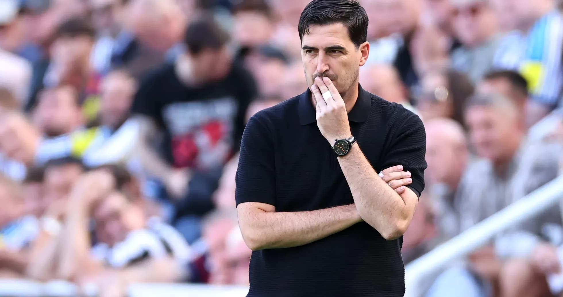 Manager observing the match with arms crossed