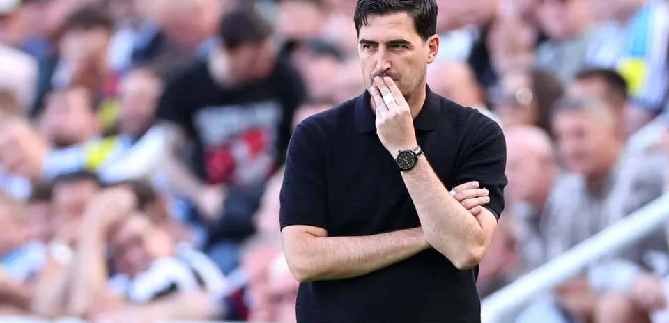 Manager observing the match with arms crossed