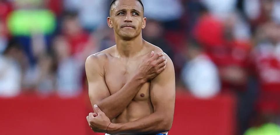 Player with no shirt holding shoulder after match