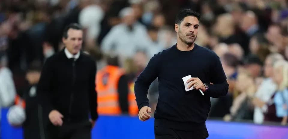 Two football managers walking on the sideline